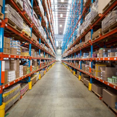 Boxes kept on row of shelves in the warehouse